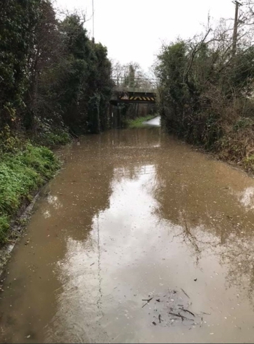 flooded muddy water under a bridge